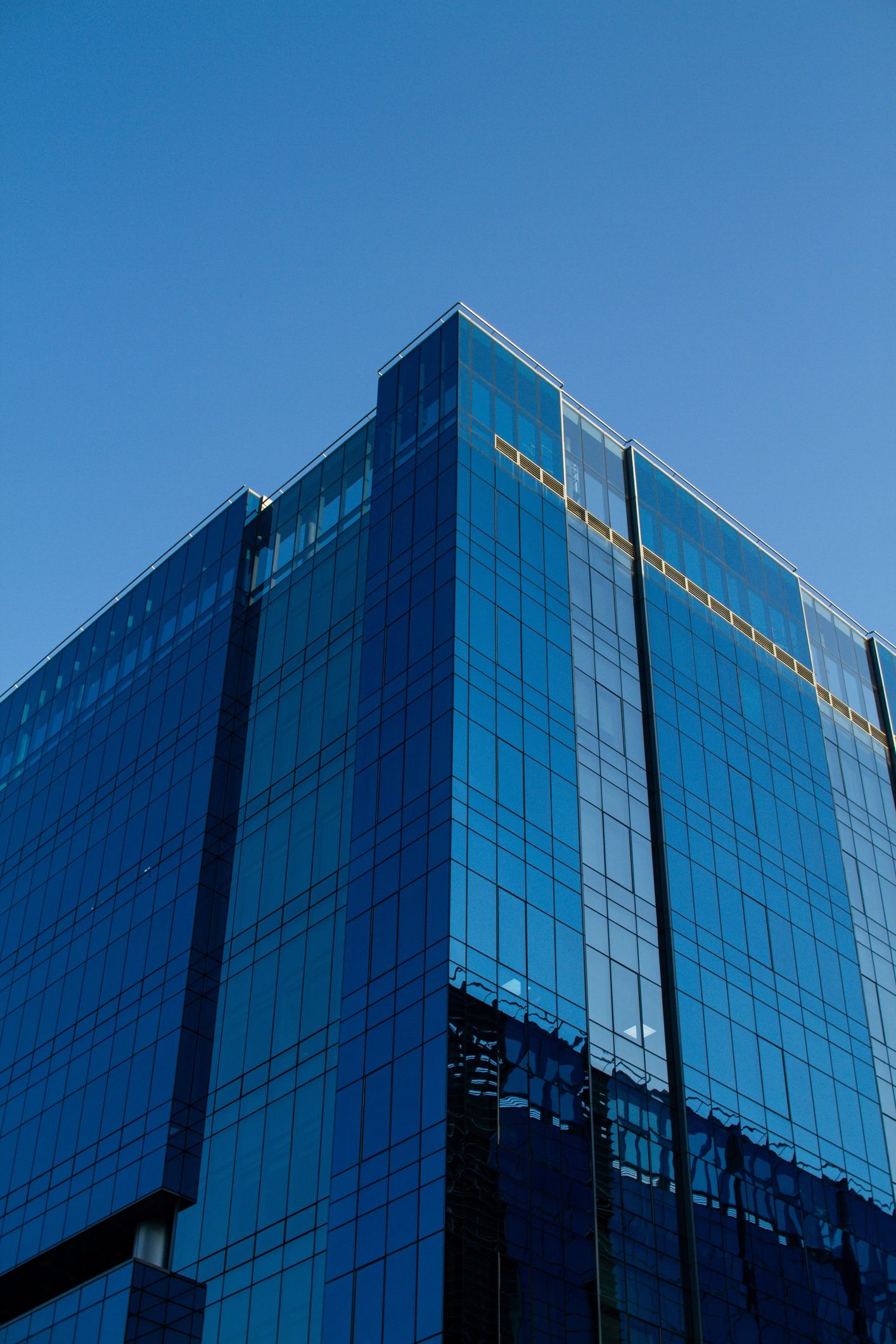 Modern glass office tower representing institutional discipline